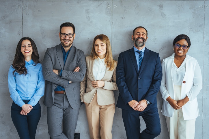 Business Colleagues Are Standing Against Wall.