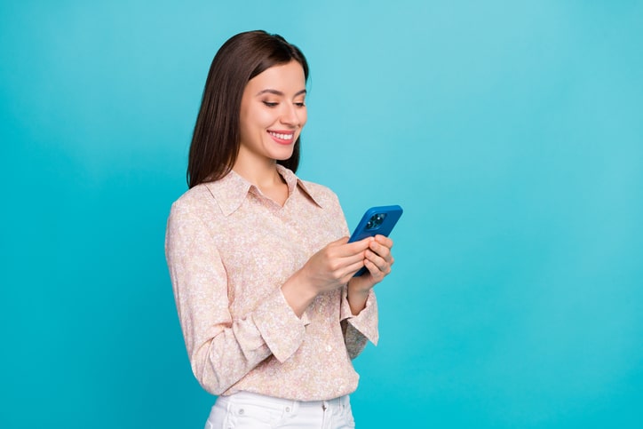 Photo Of Successful Positive Pretty Business Lady Wear Stylish Pink Shirt Office Worker Manager Chatting Her Boyfriend Remote Isolated On Blue Color Background